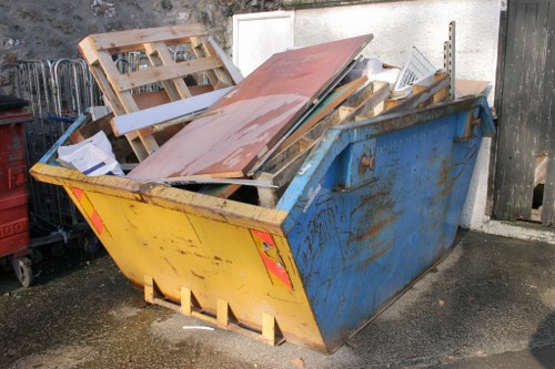 Skip hire vehicle beside a property ready for loading